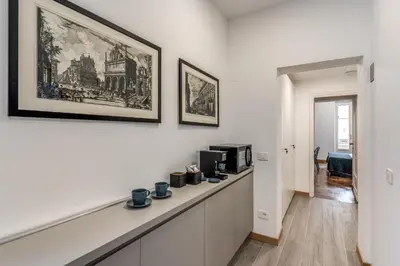 a living room with a counter with a microwave at Frattina Grand Suite - Vacanze Romane Apartments in Rome