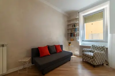 a living room with a couch and a chair at Valenziani Escape - Pretty Homes in Rome