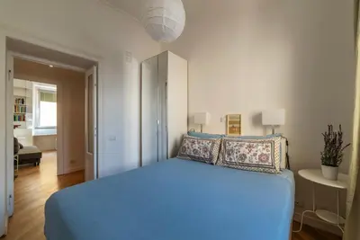 a bedroom with a blue bed in a room at Valenziani Escape - Pretty Homes in Rome