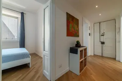 a white bedroom with a bed and a window at Valenziani Escape - Pretty Homes in Rome