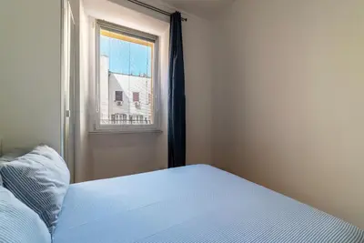 a bedroom with a bed and a window at Valenziani Escape - Pretty Homes in Rome