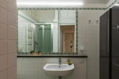 a bathroom with a sink and a mirror at Valenziani Escape - Pretty Homes in Rome