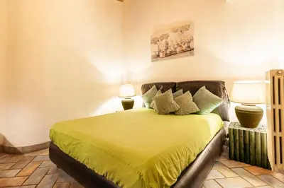 a bedroom with a bed with yellow sheets and two lamps at Campo dei Fiori Nest Apartment in Rome