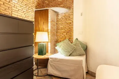 a bedroom with a bed and a table with a lamp at Campo dei Fiori Nest Apartment in Rome