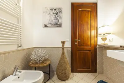 a bathroom with a sink and a vase next to a door at Campo dei Fiori Nest Apartment in Rome