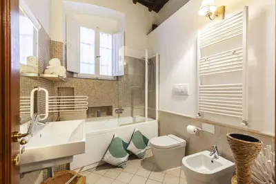 a bathroom with a toilet and a sink and a mirror at Campo dei Fiori Nest Apartment in Rome