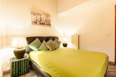 a bedroom with a yellow bed and a couch at Campo dei Fiori Nest Apartment in Rome