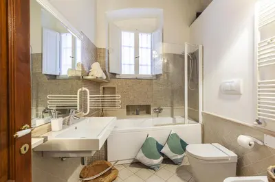 a bathroom with a sink and a tub and a toilet at Campo dei Fiori Nest Apartment in Rome