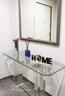 a glass table with a mirror and flowers on it at Silver Rose Guest House in Rome