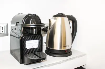 a black and silver coffee maker on a shelf at Silver Rose Guest House in Rome