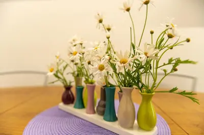 a group of vases with flowers in them on a table at Casa Caterina Holiday House - Bright Modern Apartment Near Trastevere in Rome