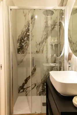 a bathroom with a shower and a sink at Casa Caterina Holiday House - Bright Modern Apartment Near Trastevere in Rome