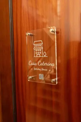 a glass door with a sign on it at Casa Caterina Holiday House - Bright Modern Apartment Near Trastevere in Rome