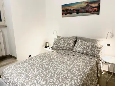 a bedroom with a bed and a sign that reads tuscolana station metro at Casa Metro A PONTELUNGO in Rome