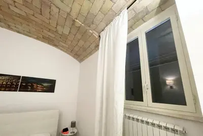 a white room with a mirror and a white cabinet at Casa Metro A PONTELUNGO in Rome