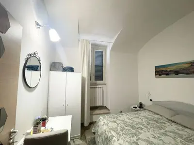 a bathroom with a mirror on the wall and a curtain at Casa Metro A PONTELUNGO in Rome