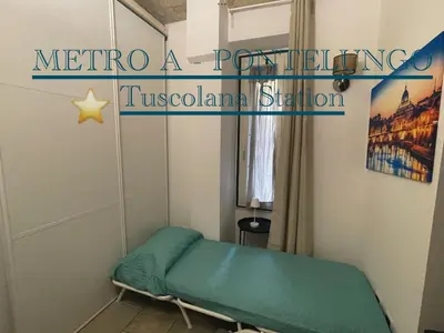 a small room with a bed and a curtain at Casa Metro A PONTELUNGO in Rome