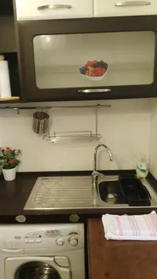 a kitchen with a sink and a stove and a microwave at Piccolo Nido in Rome