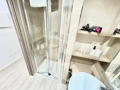 a bathroom with a shower and a white toilet at Un Letto Ideale EUR - UN LETTO IDEALE in Rome