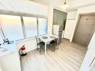 a kitchen with a table and chairs and a refrigerator at Un Letto Ideale EUR - UN LETTO IDEALE in Rome