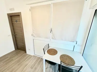 a small room with a white table and chairs at Un Letto Ideale EUR - UN LETTO IDEALE in Rome