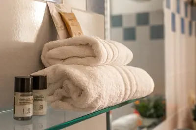 a stack of towels on a shelf in a bathroom at iFlat Bright & Comfortable Navona apartment in Rome