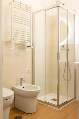 a bathroom with a shower and a toilet and a sink at Domus Angelina in Rome
