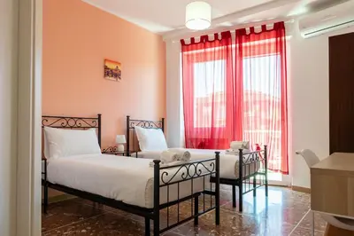 a bedroom with two beds and a window at Domus Angelina in Rome