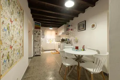 a dining room with a white table and chairs at Dolce Far Niente in Rome
