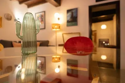 a glass vase with a cactus in a room at Dolce Far Niente in Rome