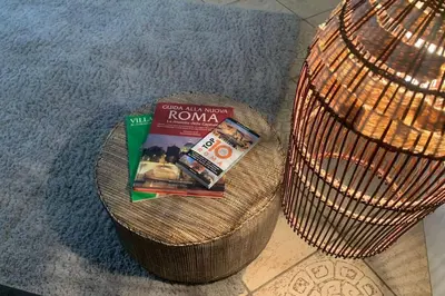 a wicker basket with a book and a magazine at Roux apartment in Rome