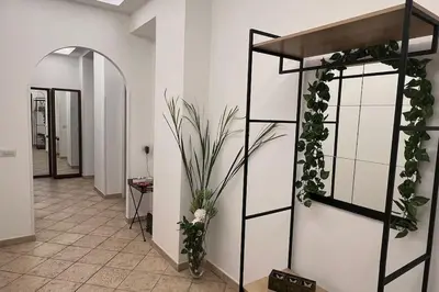 a hallway with a shelf with plants on it at Roux apartment in Rome