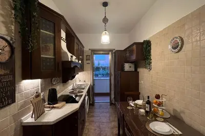 a kitchen with two sinks and a clock on the wall at Roux apartment in Rome