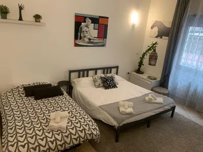 a bedroom with two beds with towels on them at Roux apartment in Rome