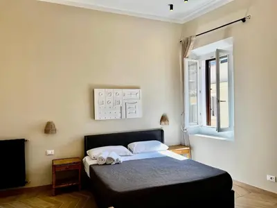a bedroom with a bed and a window at Trastevere Grand Suites in Rome