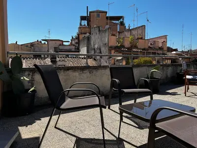 a pair of chairs and a table on a rooftop at Trastevere Grand Suites in Rome