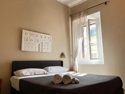 a bedroom with a bed with two towels on it at Trastevere Grand Suites in Rome