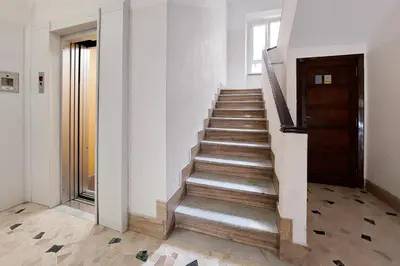 a staircase in a building with a wooden door at Vestali House in Rome