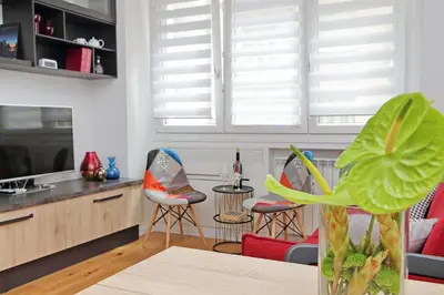 a living room with two chairs and a table at Vestali House in Rome