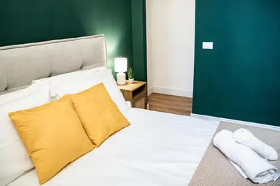 a bedroom with a bed with two towels on it at Domina Apartments Roma - San Pietro 2 in Rome