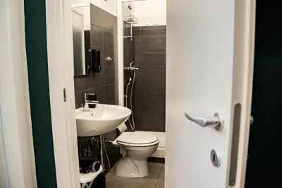a bathroom with a toilet and a sink at Domina Apartments Roma - San Pietro 2 in Rome