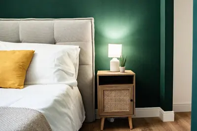 a bedroom with a bed and a night stand with a lamp at Domina Apartments Roma - San Pietro 2 in Rome