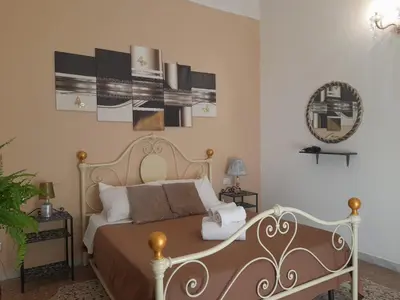 a bedroom with a bed and a mirror on the wall at Casa Roma Affittacamere in Rome