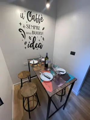 a table with two chairs and a bottle of wine at Basilica San Giovanni Appia Antica A casa di Amici in Rome