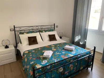 a bedroom with a large bed with a floral bedspread at Vatican flat family suite in Rome