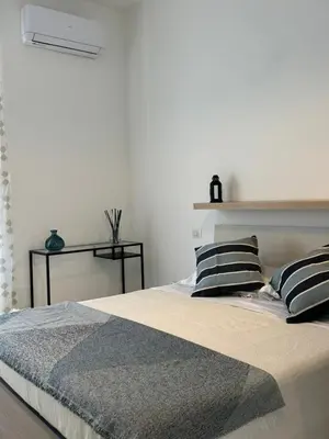a bedroom with a bed with two pillows on it at Alba Nuova Suite in Rome