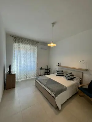 a bedroom with a bed and a large window at Alba Nuova Suite in Rome