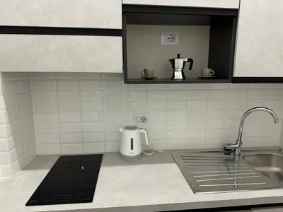 a kitchen with a sink and a counter top with a mixer at Alba Nuova Suite in Rome
