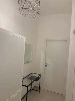 a white room with a glass table and a mirror at Alba Nuova Suite in Rome