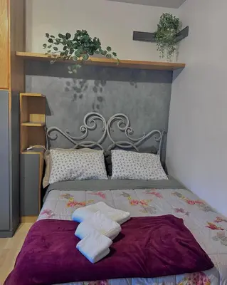 a bedroom with a bed with two towels on it at nel cuore di Roma monolocale con piscina in Rome